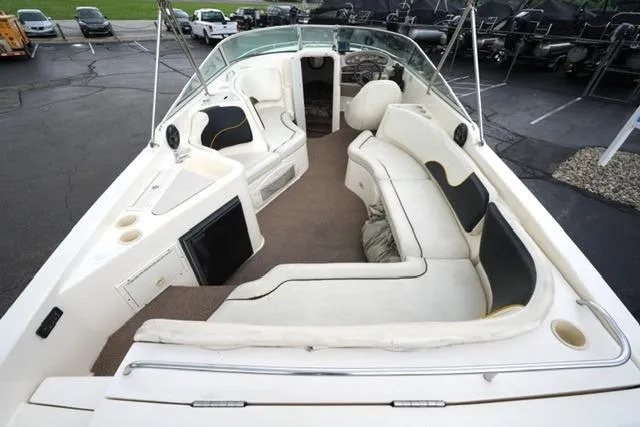Slide: The Image of 2002 Rinker 276 Captiva Cuddy boat interior with spacious seating and modern amenities. - 8