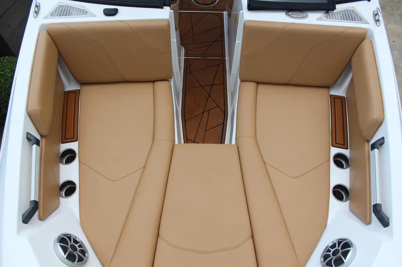 Slide: The Image of Luxurious tan seating in 2021 ATX Surf Boats 24 Type-S, featuring cup holders and speakers. - 14