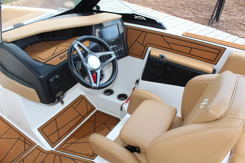 Slide: The Image of 2021 ATX Surf Boats 24 Type-S interior with tan seating and modern dashboard. - 15