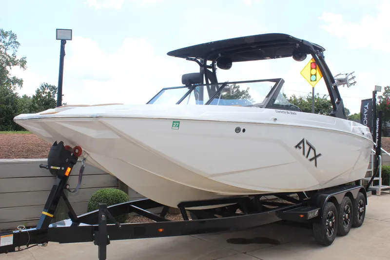 Slide: The Image of 2021 ATX Surf Boats 24 Type-S on trailer, sleek design, outdoor display. - 7