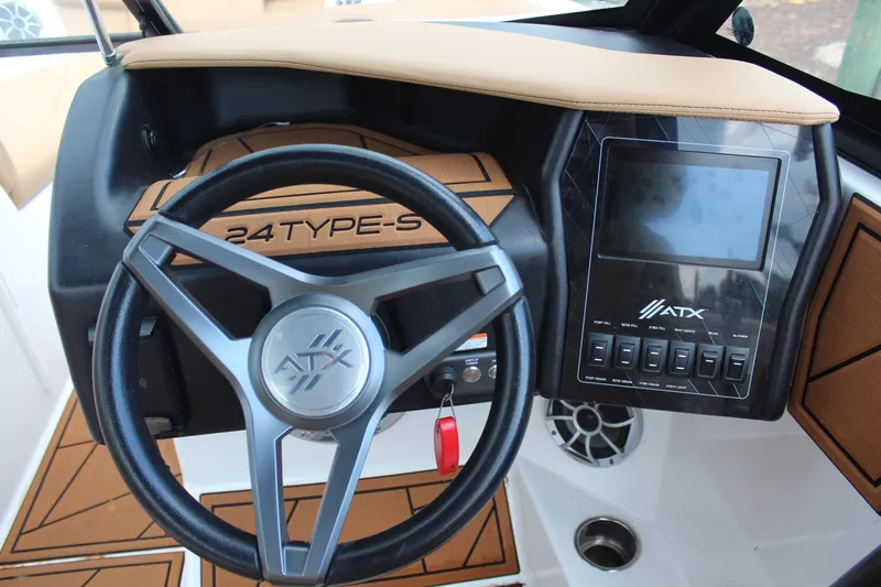 Slide: The Image of 2021 ATX Surf Boats 24 Type-S dashboard with steering wheel and control panel. - 16