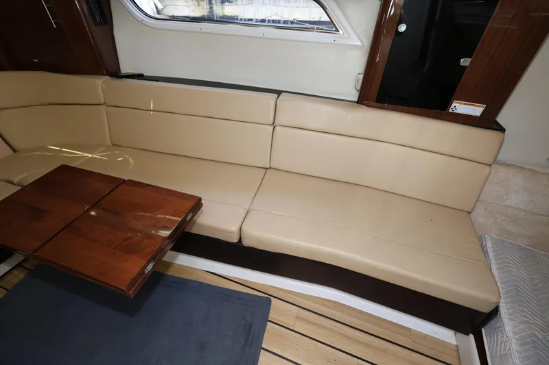 Slide: The Image of Interior of 2015 Regal 35 Sport Coupe with beige seating and wooden table. - 16