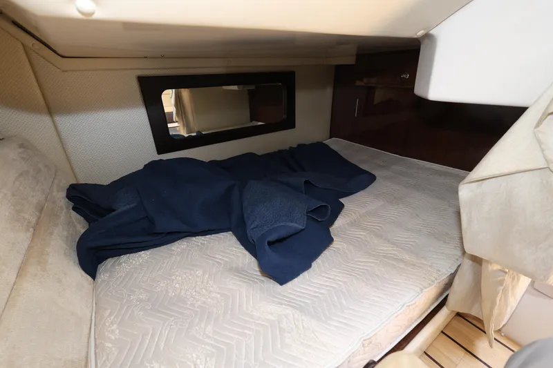 Slide: The Image of 2015 Regal 35 Sport Coupe cabin interior with bed and blue blanket. - 22