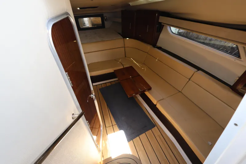 Slide: The Image of Interior of 2015 Regal 35 Sport Coupe with beige seating and wooden accents. - 15