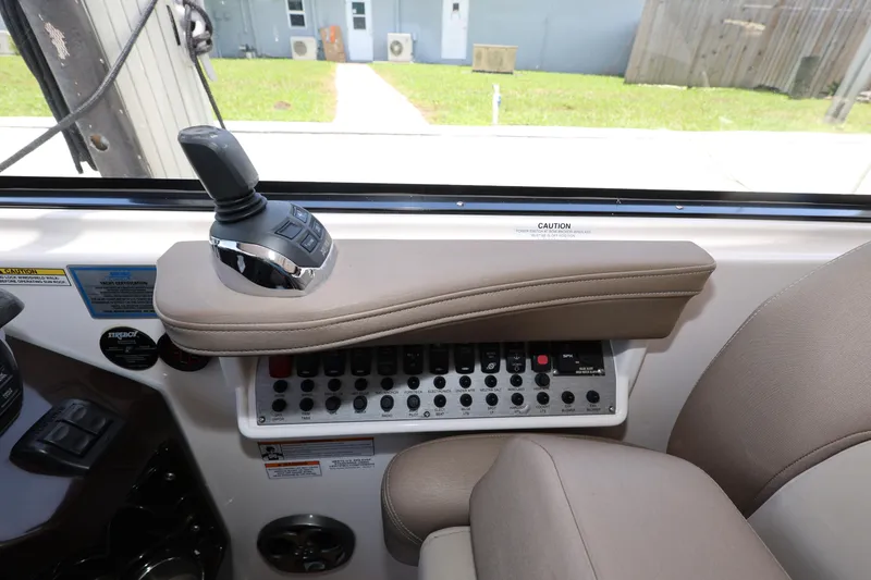 Slide: The Image of Control panel of a 2015 Regal 35 Sport Coupe boat with joystick and switches. - 12