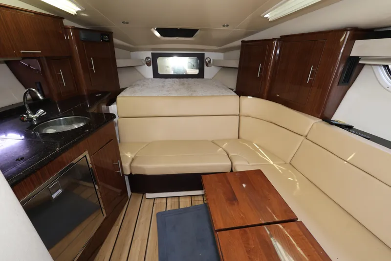Slide: The Image of Luxurious interior of a 2015 Regal 35 Sport Coupe with beige seating and wooden cabinetry. - 17