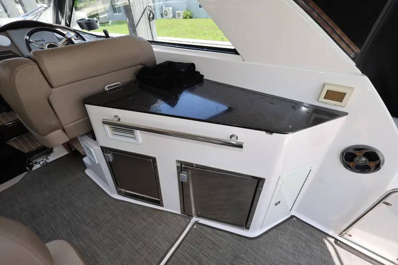 Slide: The Image of Interior of 2015 Regal 35 Sport Coupe with sleek kitchenette and modern design. - 8