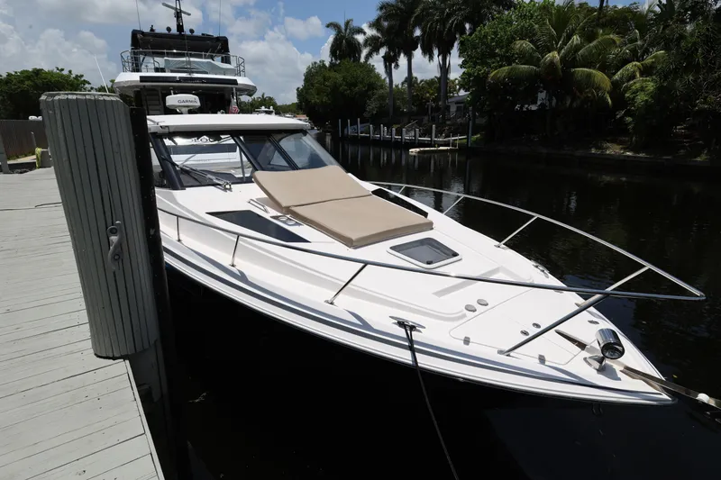 The Image of 2015 Regal 35 Sport Coupe docked by a lush, tropical canal. - 5