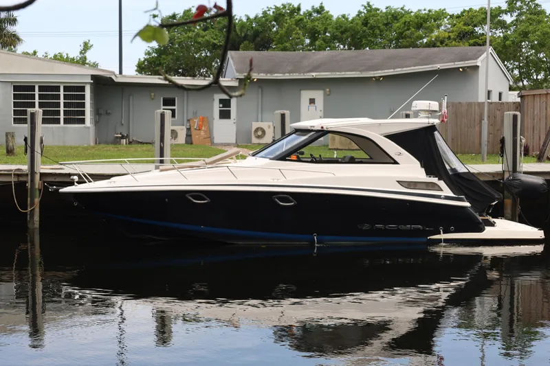Slide: The Image of 2015 Regal 35 Sport Coupe docked by a waterfront building. - 3