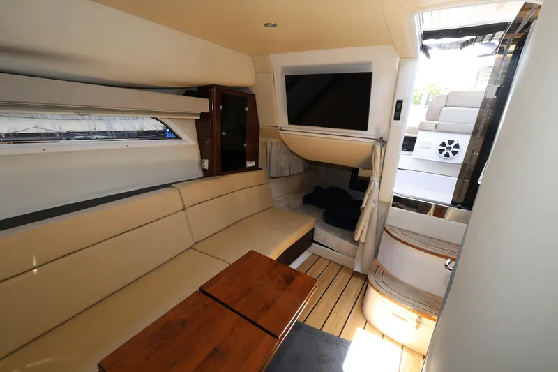 Slide: The Image of Interior of 2015 Regal 35 Sport Coupe with beige seating and wooden accents. - 20