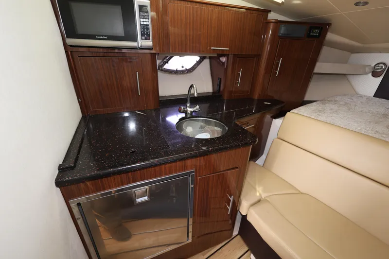 Slide: The Image of Luxurious interior of 2015 Regal 35 Sport Coupe with kitchenette and seating area. - 18