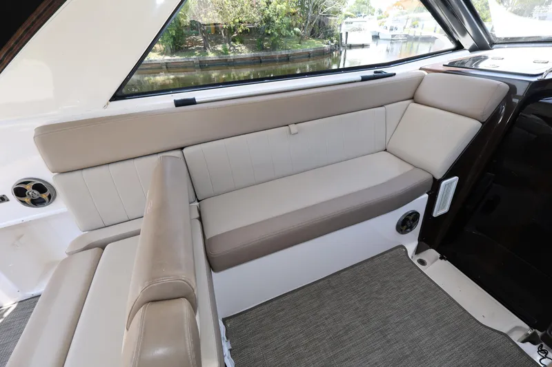 Slide: The Image of Interior seating of 2015 Regal 35 Sport Coupe, featuring beige upholstery and window view. - 9