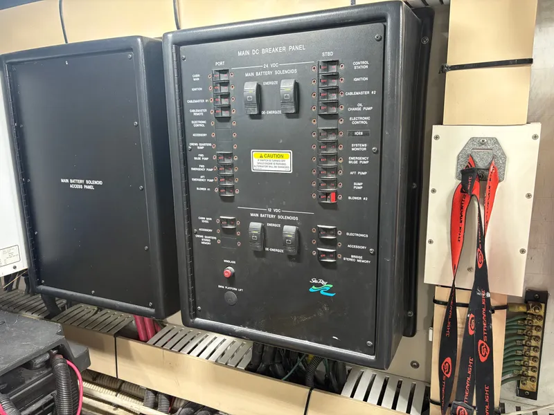 Slide: The Image of Main breaker panel of a 2000 Sea Ray 560 Sedan Bridge with various switches and indicators. - 44