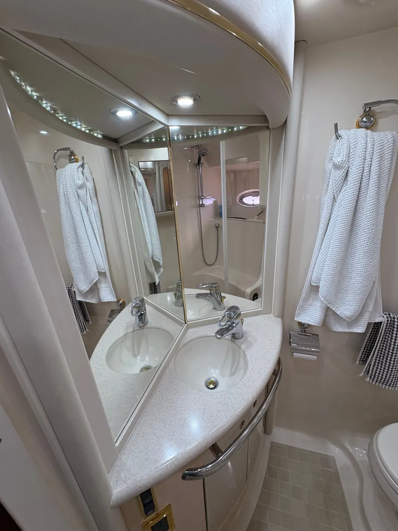 Slide: The Image of The image shows an elegant yacht bathroom with a double sink and mirrors. - 25