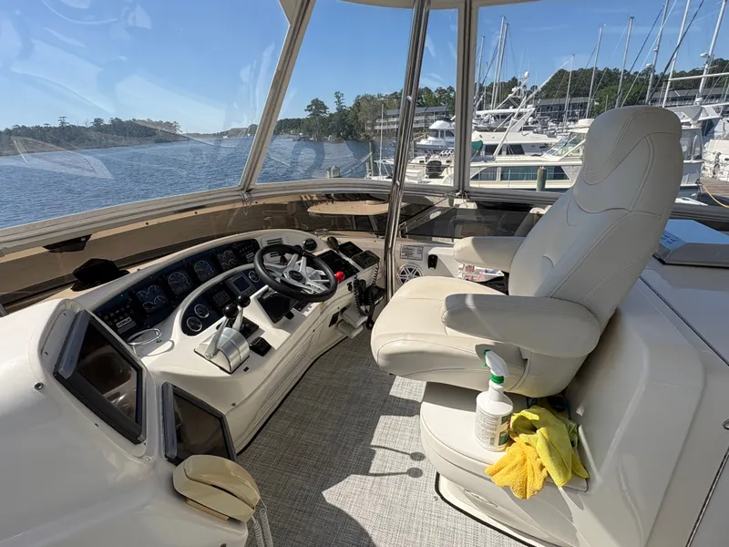 Slide: The Image of The image shows the helm of a 2000 Sea Ray 560 Sedan Bridge. It features a comfortable captain's chair and modern instruments. - 9