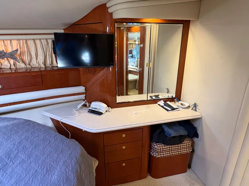 Slide: The Image of Cabin with mirror, TV, and desk in a 2000 Sea Ray 560 Sedan Bridge. - 22