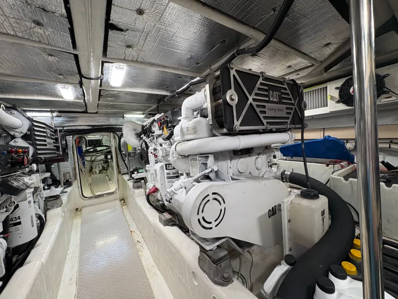 Slide: The Image of The engine room of a 2000 Sea Ray 560 Sedan Bridge features a large CAT engine. - 46