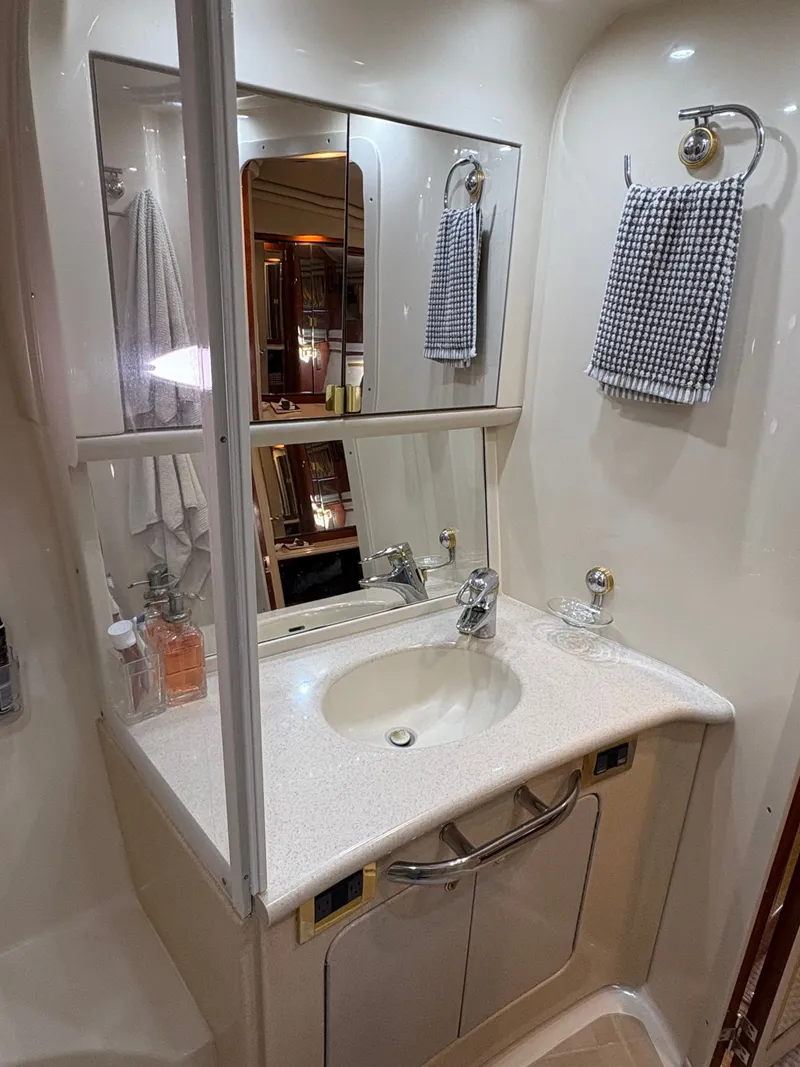 Slide: The Image of A sleek bathroom with a sink, mirrors, and towels hanging on the wall. - 24