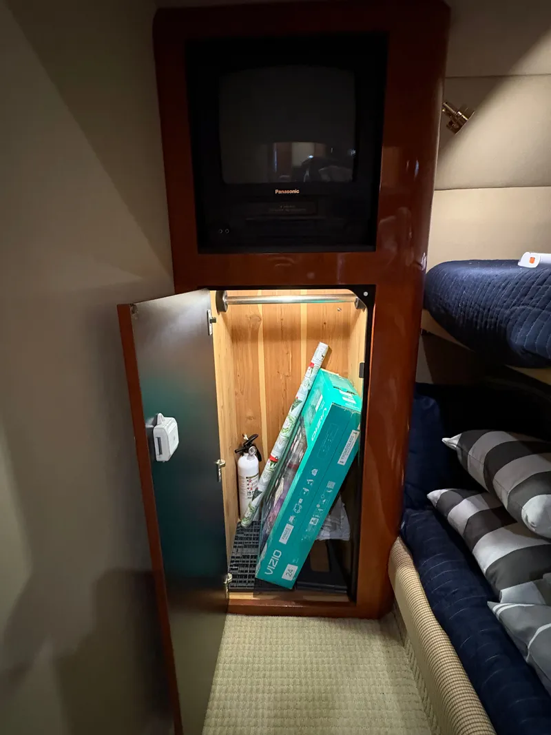 Slide: The Image of A cabin with a TV and an open cabinet below, containing various items. - 29