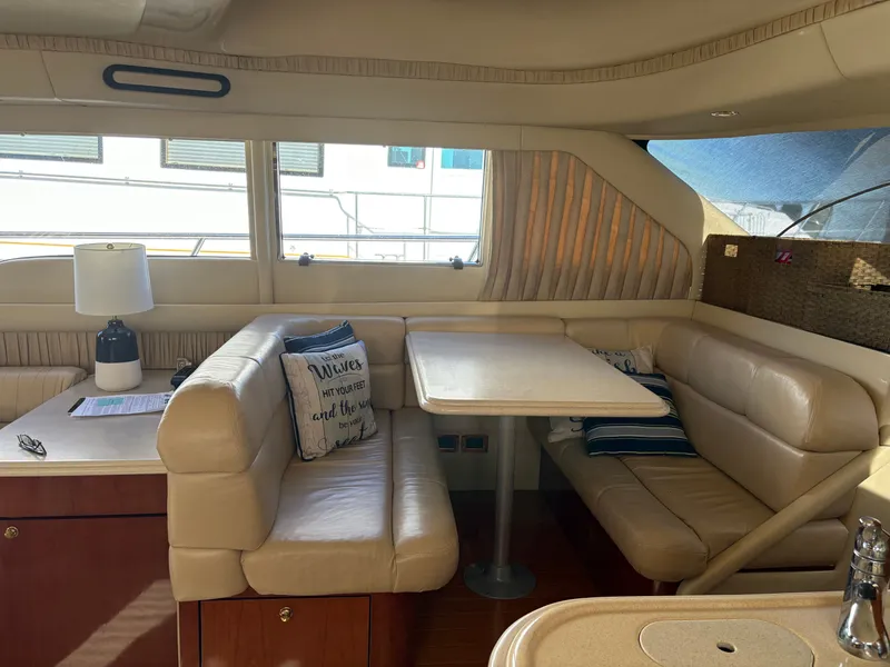 Slide: The Image of Interior of a 2000 Sea Ray 560 Sedan Bridge with beige leather and wooden furnishings. - 32