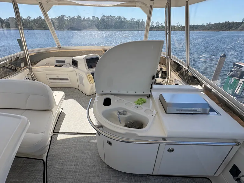 Slide: The Image of The image shows the cockpit of a 2000 Sea Ray 560 Sedan Bridge with an open wet bar. - 11