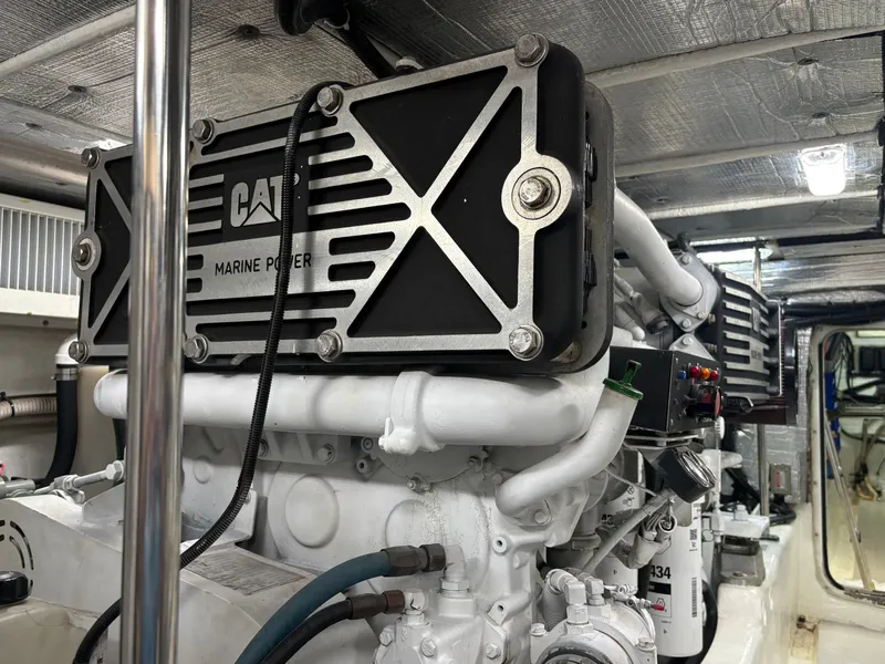Slide: The Image of The engine room of a 2000 Sea Ray 560 Sedan Bridge features powerful CAT engines. - 48