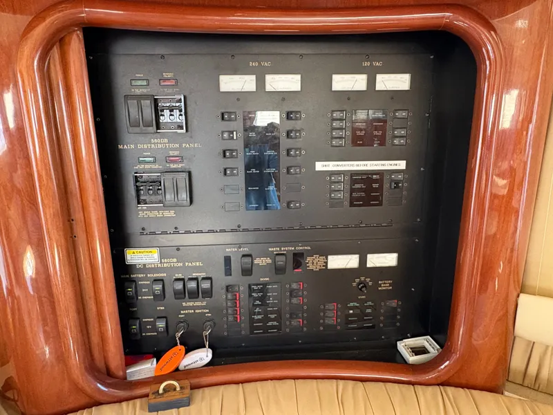 Slide: The Image of Electrical control panel in a 2000 Sea Ray 560 Sedan Bridge, featuring various switches and gauges. - 43