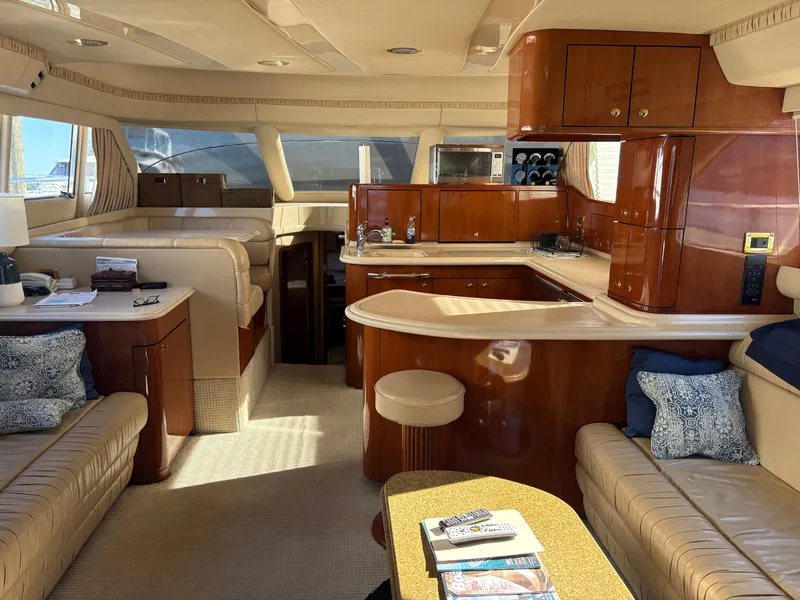 Slide: The Image of Interior of a 2000 Sea Ray 560 Sedan Bridge with elegant wood furnishings and comfortable seating. - 39