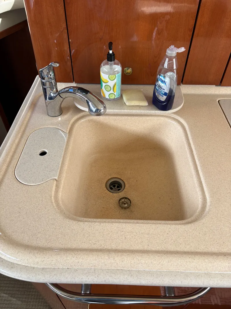 Slide: The Image of A sink with a faucet and soap dispensers on a countertop. - 37