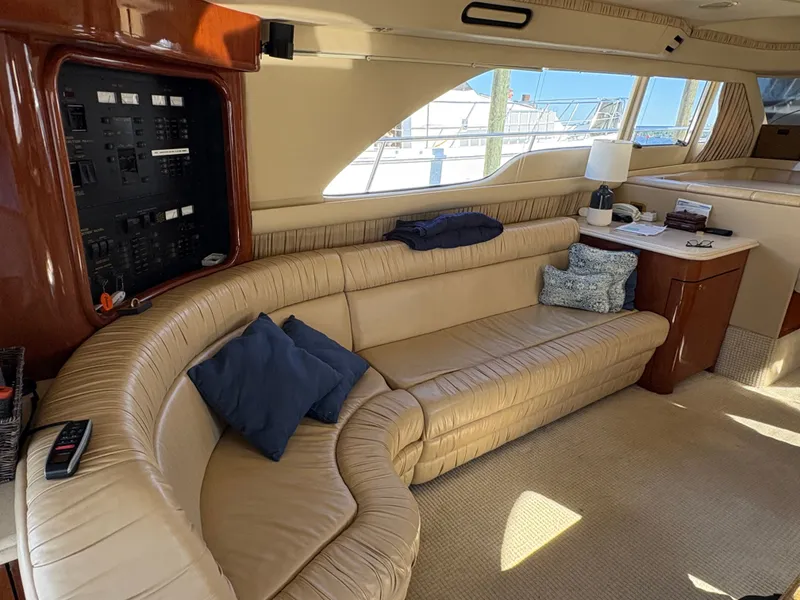 Slide: The Image of Interior of a 2000 Sea Ray 560 Sedan Bridge with beige leather sofa and control panel. - 42