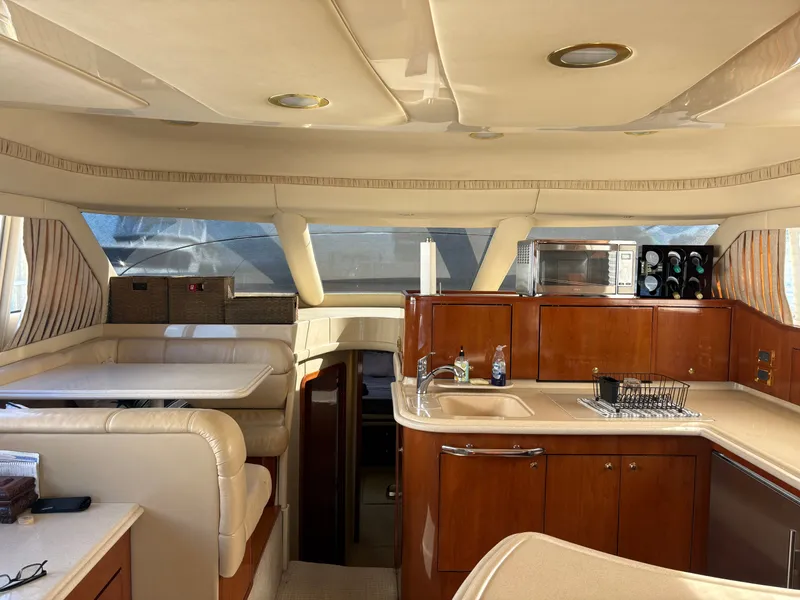 Slide: The Image of Interior of a 2000 Sea Ray 560 Sedan Bridge with elegant kitchen and seating area. - 31