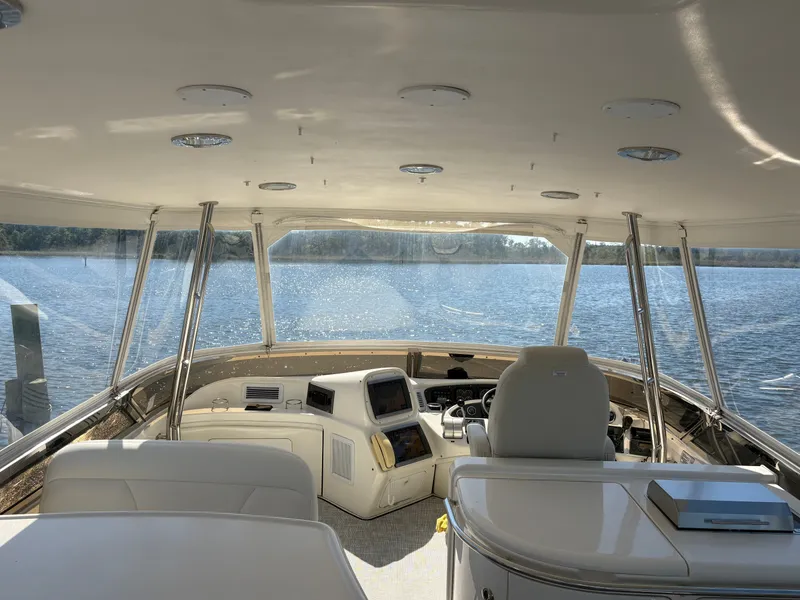 Slide: The Image of The image shows the cockpit of a 2000 Sea Ray 560 Sedan Bridge overlooking the water. - 13