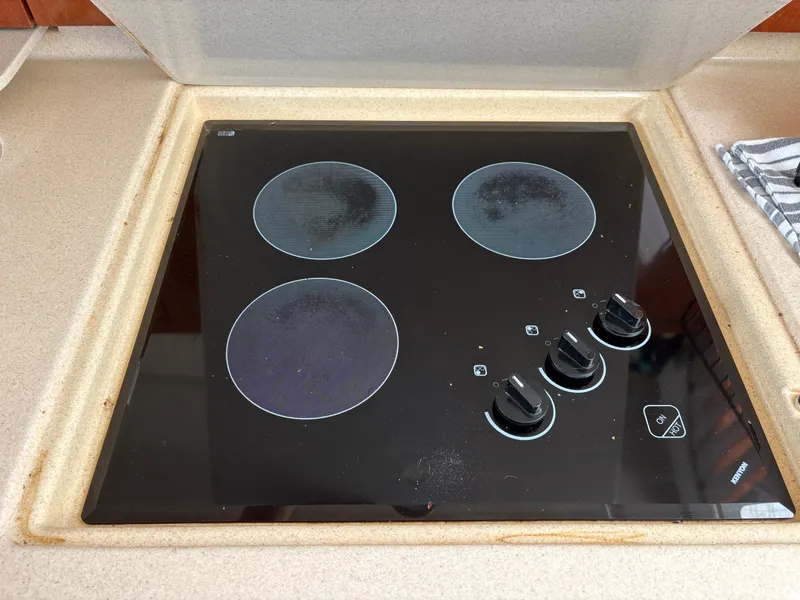 Slide: The Image of A built-in cooktop with four burners and control knobs on a countertop. - 36