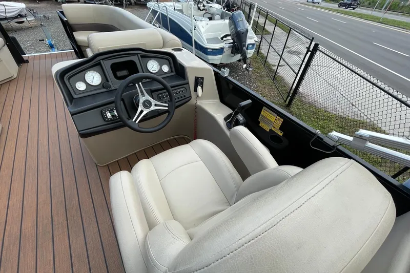 Slide: The Image of 2021 Bentley Pontoons 240 CRUISE helm with steering wheel and gauges, beige seating. - 5