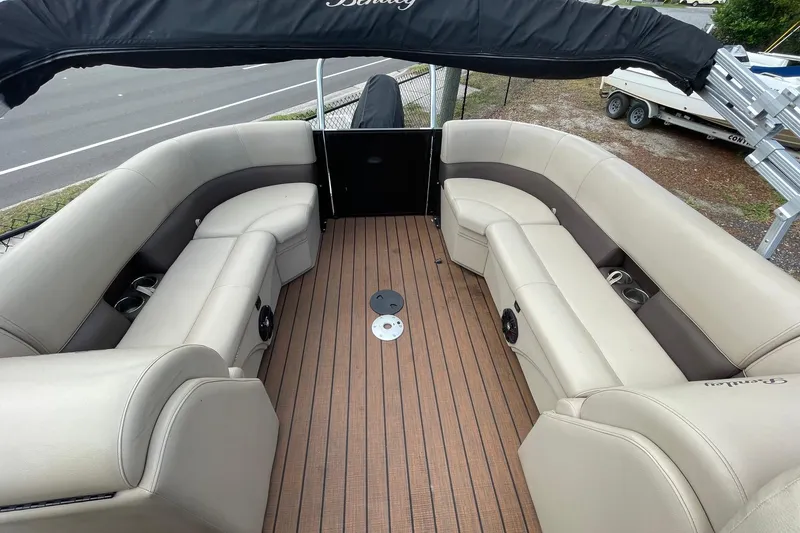 Slide: The Image of 2021 Bentley Pontoons 240 CRUISE interior with beige seating and wood-style flooring. - 4