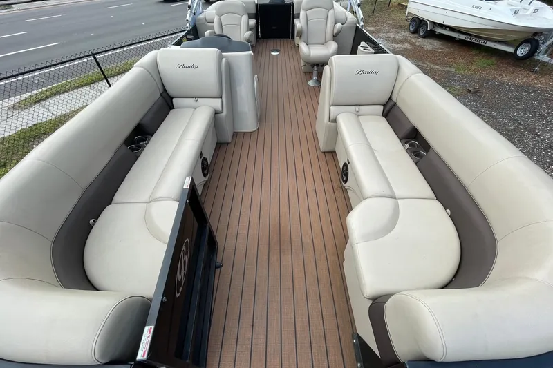 Slide: The Image of 2021 Bentley Pontoons 240 CRUISE interior with beige seating and wood-style flooring. - 7