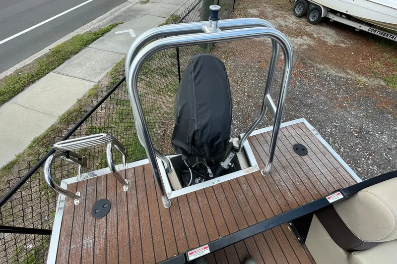 Slide: The Image of 2021 Bentley Pontoons 240 CRUISE boat deck with stainless steel railing and covered motor. - 3