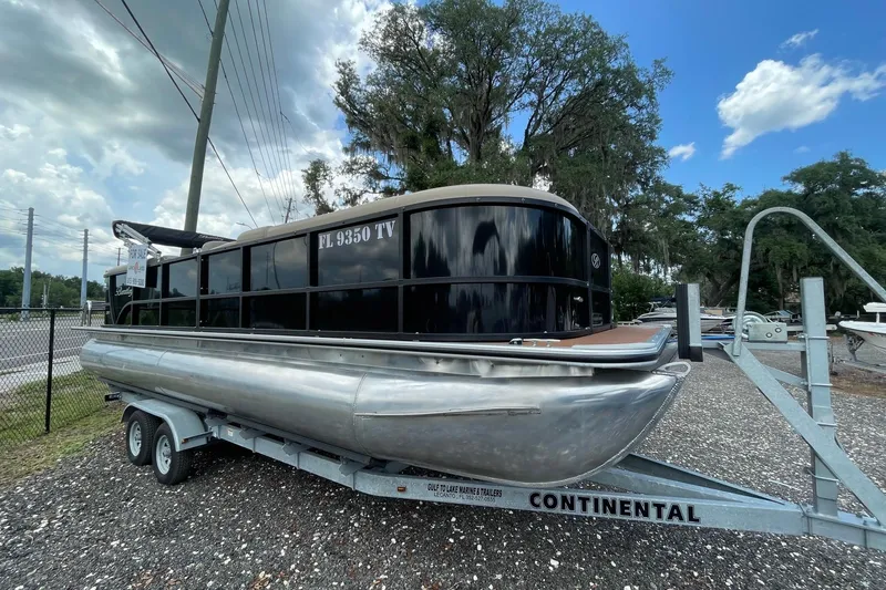 The Image of 2021 Bentley Pontoons 240 CRUISE on trailer, parked outdoors under cloudy sky. - 0