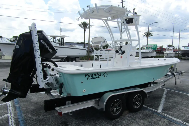 Slide: The Image of 2024 Piranha Boatworks Casador B2250 on trailer, featuring Mercury outboard motor. - 3