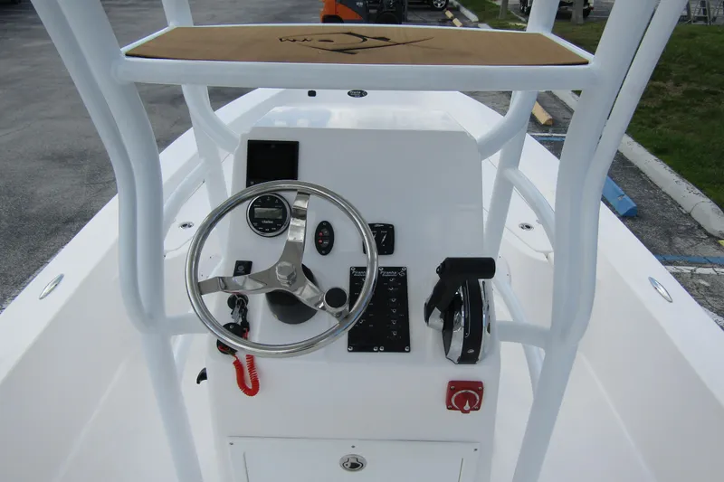 Slide: The Image of 2024 Piranha Boatworks Casador B2250 helm with steering wheel and control panel. - 11