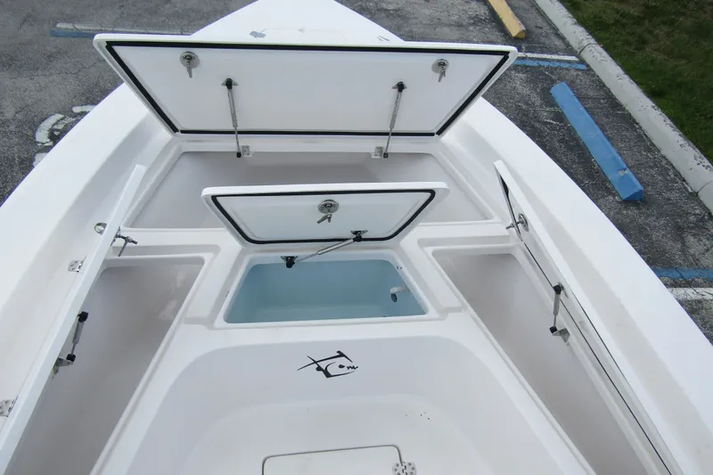 Slide: The Image of 2024 Piranha Boatworks Casador B2250 storage compartments open, showcasing spacious design. - 9