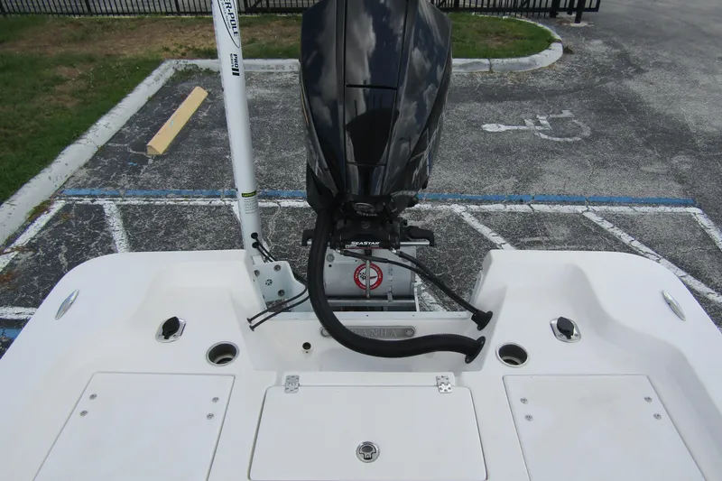 Slide: The Image of 2024 Piranha Boatworks Casador B2250 with outboard motor in parking lot. - 14