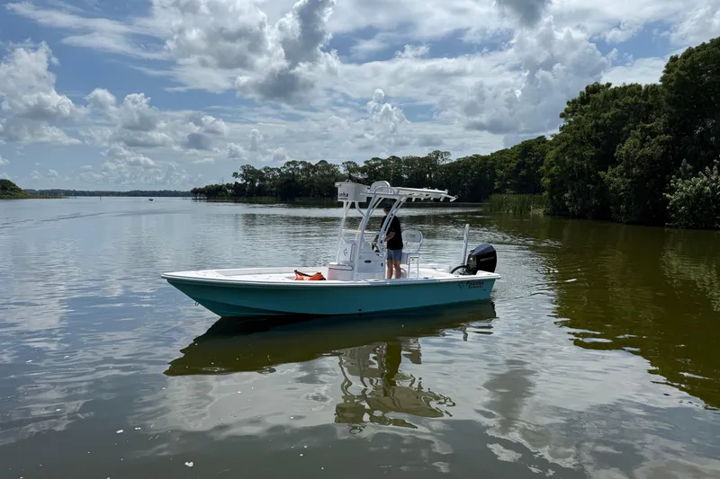 Slide: The Image of 2024 Piranha Boatworks Casador B2250 on a serene lake under a cloudy sky. - 17