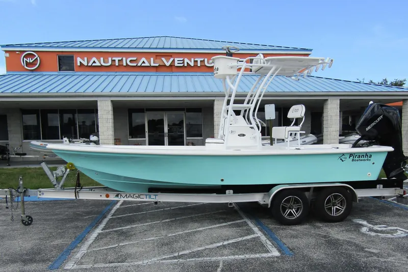 Slide: The Image of 2024 Piranha Boatworks Casador B2250 on trailer outside Nautical Ventures store. - 6