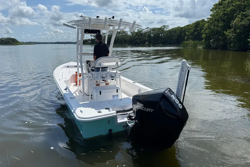 Slide: The Image of 2024 Piranha Boatworks Casador B2250 on calm water, featuring a powerful Mercury engine. - 22