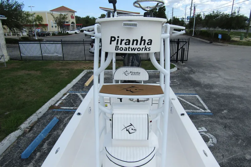 Slide: The Image of 2024 Piranha Boatworks Casador B2250, sleek design, parked outdoors. - 10