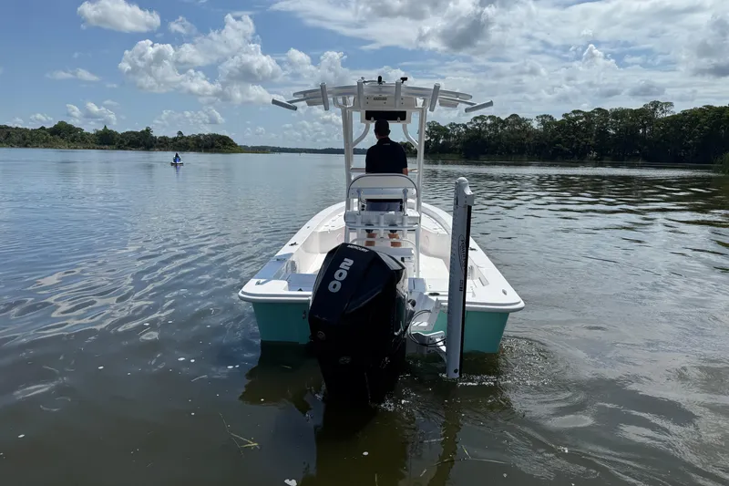 Slide: The Image of 2024 Piranha Boatworks Casador B2250 on calm water, rear view with outboard motor. - 23