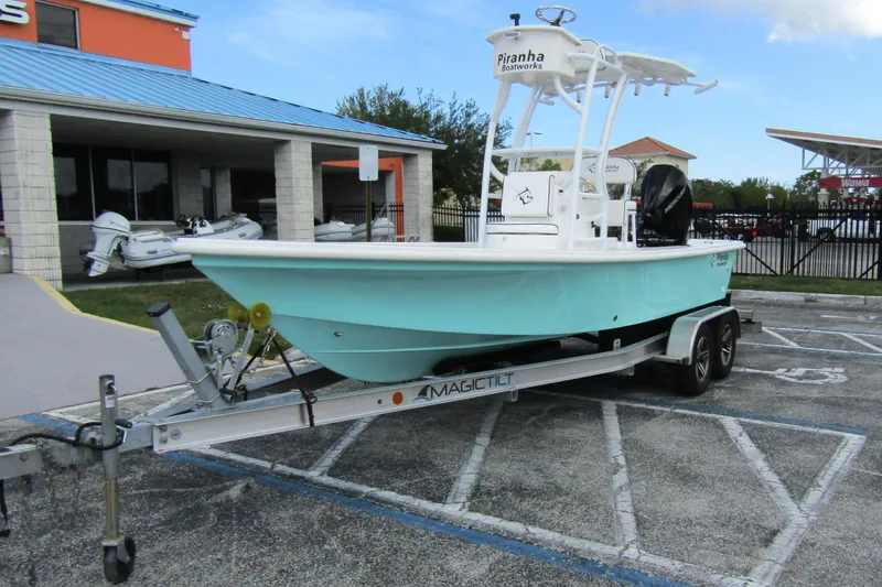 Slide: The Image of 2024 Piranha Boatworks Casador B2250 on trailer, parked outdoors near a building. - 7
