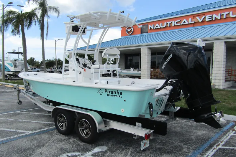 Slide: The Image of 2024 Piranha Boatworks Casador B2250 on trailer, parked outside Nautical Ventures store. - 5