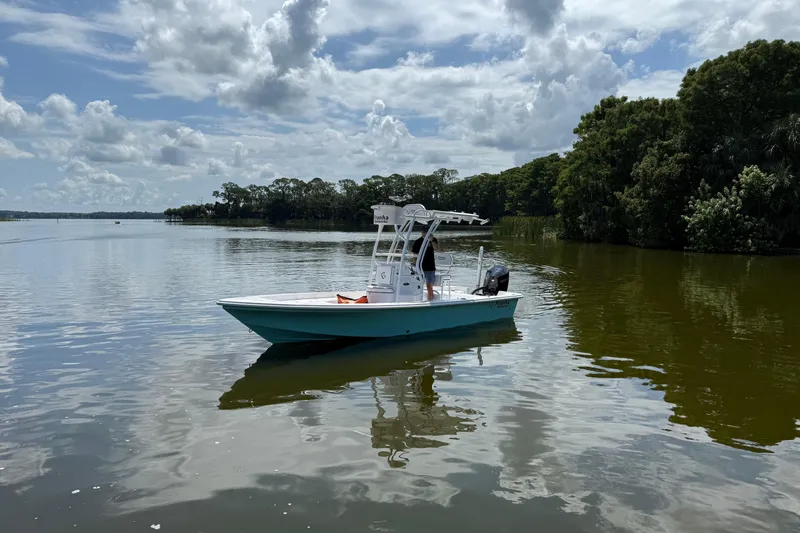 The Image of 2024 Piranha Boatworks Casador B2250 on a serene lake under a cloudy sky. - 16